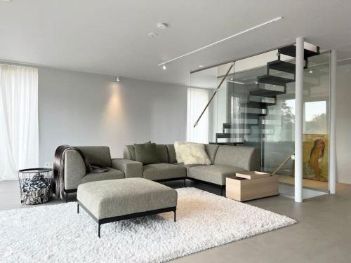 a living room with a couch and a rug at Exklusiv villa med sjöutsikt och egen brygga in Nacka