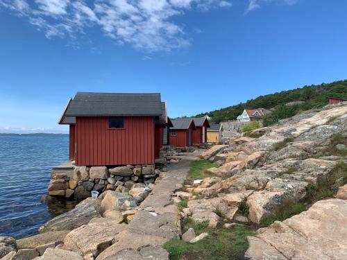 a row of houses on the rocks near the water at Studio Hamra in Särö
