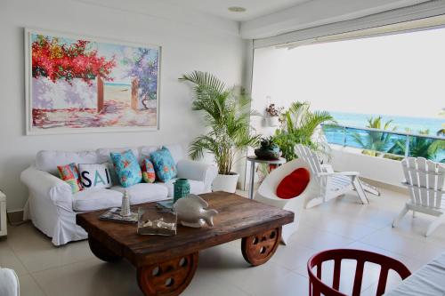 a living room with a couch and a coffee table at LasOlasTower-JuanDolio-2Br-3Bds-7Px-WiFi-HugeTerrace-SeaView in Guayacanes