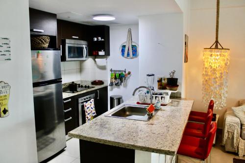 a kitchen with a sink and a counter top at LasOlasTower-JuanDolio-2Br-3Bds-7Px-WiFi-HugeTerrace-SeaView in Guayacanes