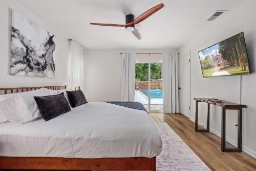 a bedroom with a bed and a ceiling fan at The Monterey -- Private Pool & Grill - 4 KING Beds in Gainesville