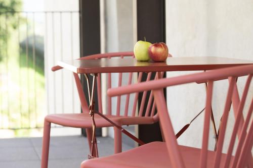 a table with a chair and two apples on it at Pramian1394 in Cermes
