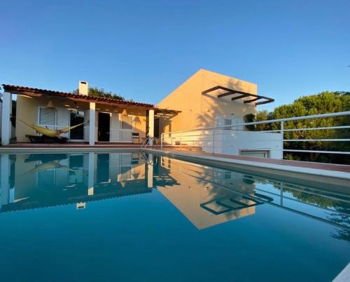 a villa with a swimming pool next to a house at A Casa da Lua in Tomar