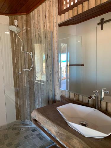 a bathroom with a large sink and a shower at Positano Village in Canoa Quebrada