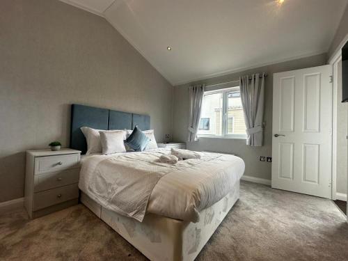 a bedroom with a large bed and a window at WH - Smugglers Lodge in Aberaeron
