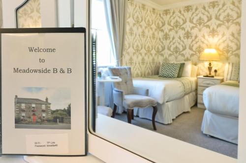 a welcome sign in a hotel room with a bedroom at Meadowside B&B in Bunclody