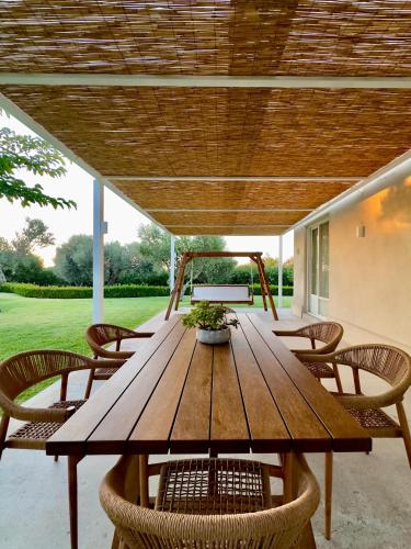 a wooden table and chairs under a wooden ceiling at Ta Spitakia in Kos Town