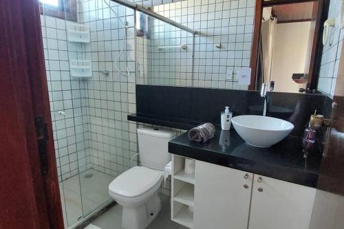 a bathroom with a toilet and a sink at Casa de praia Vista Mare Beira-mar in Barra de São Miguel