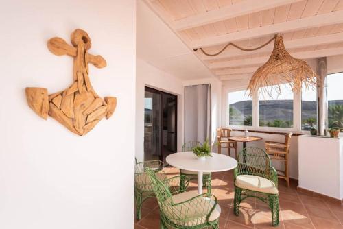a room with a table and chairs and a kitchen at Ático San Agustín in La Lajita