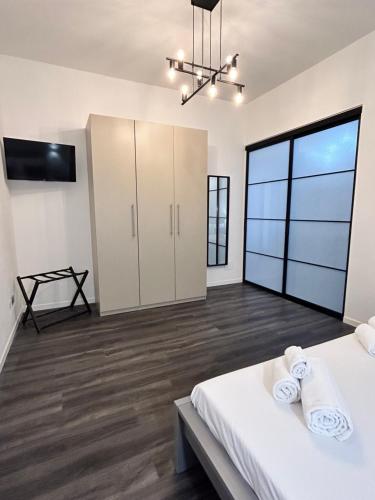 a large room with two beds and a flat screen tv at TEZONE SEVEN Apartments in Verona