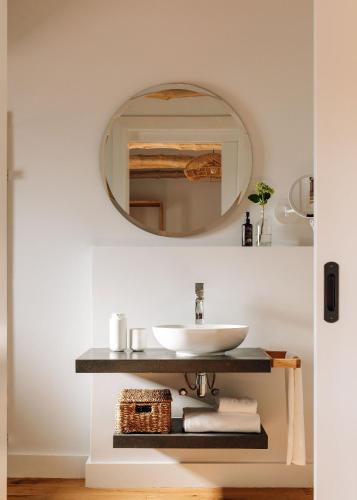 a bathroom with a sink and a mirror at Adega do Fogo in São Roque do Pico