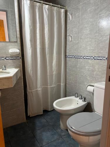 a bathroom with a toilet and a sink and a shower at Hosteria Prince in Chajarí