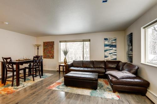 a living room with a leather couch and a table at Waterfront Apt, Walk to Town and Coastal Trail! in Anchorage