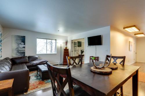 a living room with a table and a couch at Waterfront Apt, Walk to Town and Coastal Trail! in Anchorage