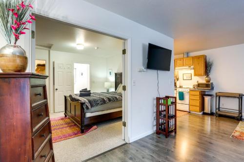 a bedroom with a bed and a kitchen at Waterfront Apt, Walk to Town and Coastal Trail! in Anchorage