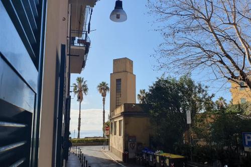 a view of a building and the ocean from a street at Via Vernazza 30 mt dal mare in Cogoleto