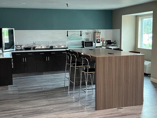 a kitchen with a island with bar stools at Sleep Inn Marion - Cedar Rapids in Cedar Rapids