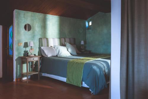 a bedroom with a bed with a green wall at Chiama Ride the Beauty Assisi in Assisi