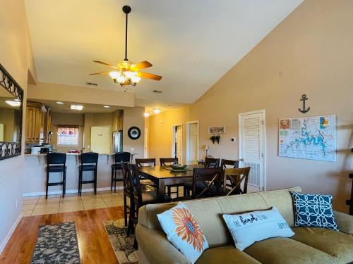 a living room and dining room with a couch and a table at Rockwood Condos on Table Rock Lake With Boat Slips in Branson