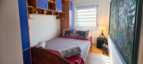 a small bedroom with a bed and a couch at Dina cozy apartment in Zemun