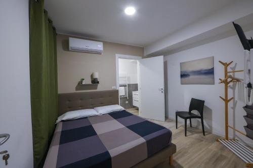 a bedroom with a bed and a chair in it at Residence della Accademia in Modena