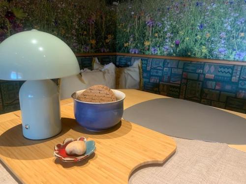 a table with a lamp and a bowl of food on it at Auszeit 2 0 Digital Detox in Obergrünburg