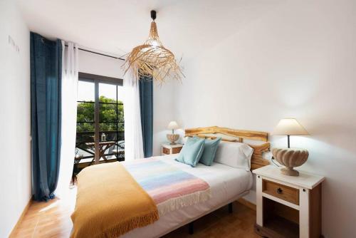 a bedroom with a bed and a large window at Apartamento La Falúa in Lajita