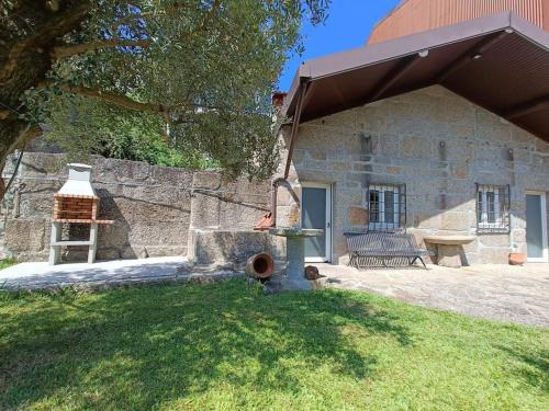 a fire hydrant in front of a stone building at Casa do Jardim in Guimarães