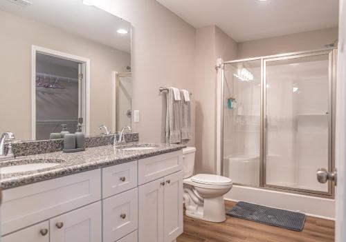 a white bathroom with a shower and a toilet at River Birch at Ducks Landing in Aberdeen