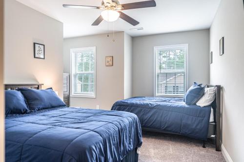 a bedroom with two beds and a ceiling fan at The Dogwood at Ducks Landing in Aberdeen