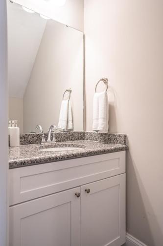a bathroom with a sink and a mirror at The Sequoia at Ducks Landing in Aberdeen