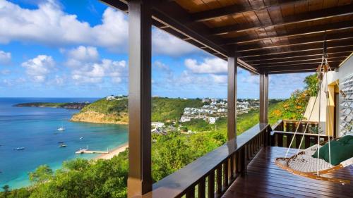 a balcony with a view of the ocean at Culturally Luxurious Villa- ViewFort Estate in Ebenezer