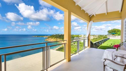 a view of the ocean from the balcony of a house at Culturally Luxurious Villa- ViewFort Estate in Ebenezer