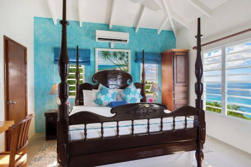 a bedroom with a bed in a room with blue walls at Culturally Luxurious Villa- ViewFort Estate in Ebenezer