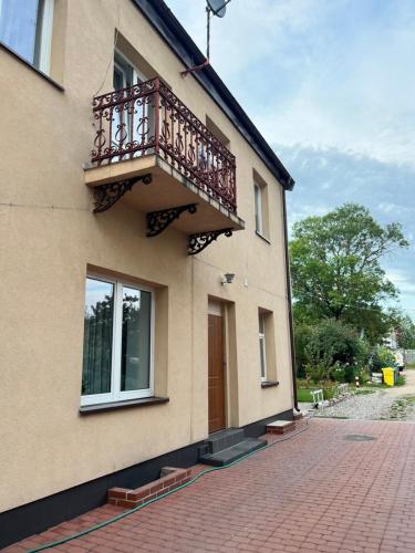 a building with a balcony on the side of it at Pretty Apartment Centrum in Suwałki