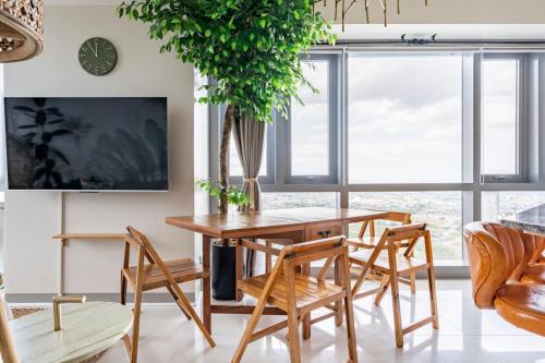 a dining room with a wooden table and chairs at Tree of Life Penthouse 3BR w Gym Pool Sauna More in Manila
