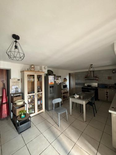 une cuisine avec une table et des chaises dans une pièce dans l'établissement Villa entière pour famille, à Aramon