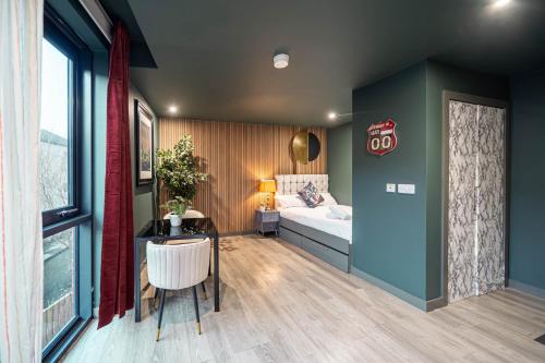 a bedroom with a bed and a desk and a table at Prime Sheffield Apartments in Sheffield