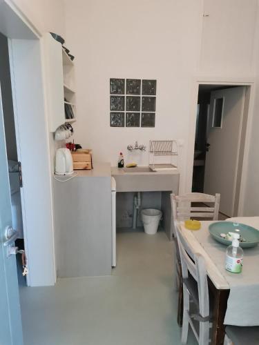 a kitchen with a table and a counter top at Thalassa4 in Andros