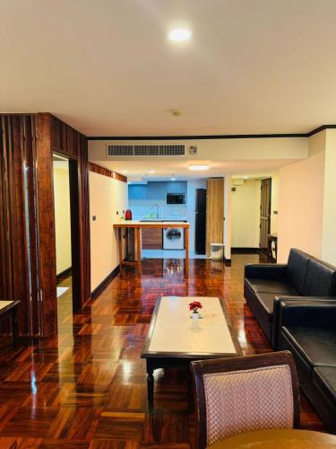 a living room with a couch and a table at Rent Omni Tower Apartments Nana Bangkok - Prime Sukhumvit location in Bangkok