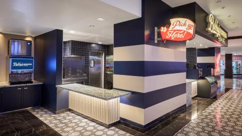 a bar in a restaurant with a coca cola sign at Harrah's Las Vegas, A Caesars Destination in Las Vegas