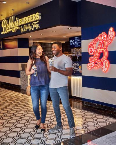a man and a woman standing in front of a store at Harrah's Las Vegas, A Caesars Destination in Las Vegas