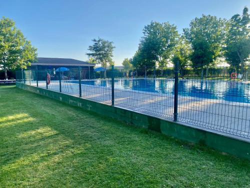 a tennis court in a park with a fence at Casa Pernila in Tábara