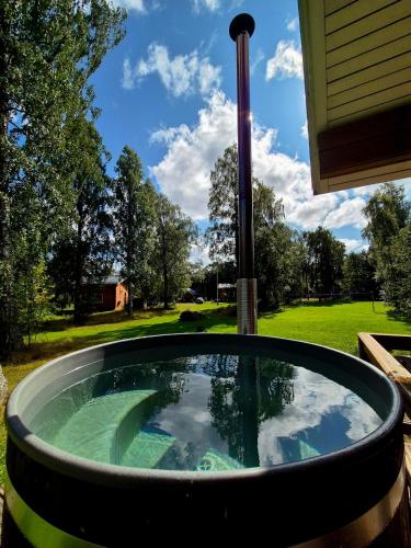 a hot tub in the backyard of a house at Holiday Village Anttoora - Anttooran Lomakylä in Pori