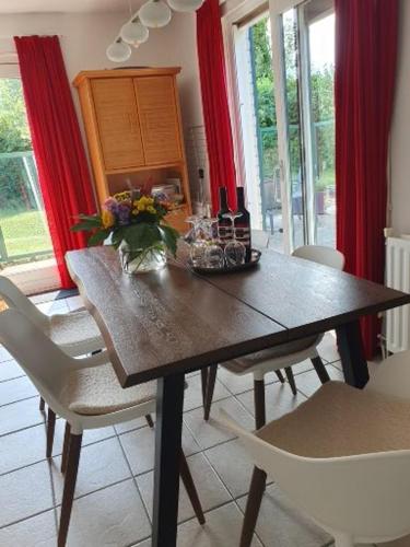a dining room with a wooden table and chairs at Ferienhaus Strandnah in Breskens