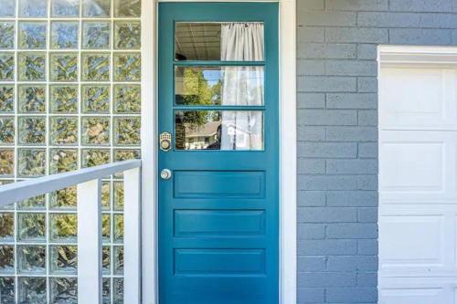 a blue door on a house with a window at Stylish 1br Studio Steps To Shops & Dining in Orlando