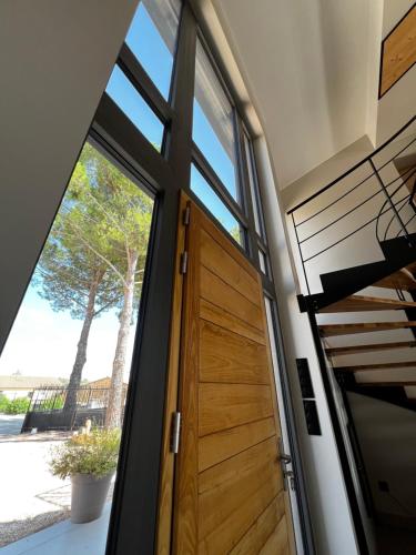 une porte pivotante dans une maison avec une fenêtre dans l'établissement CASAjuma, à Magalas