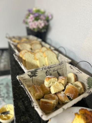 a tray of bread and pastries on a table at Hotel GranDourados in Dourados