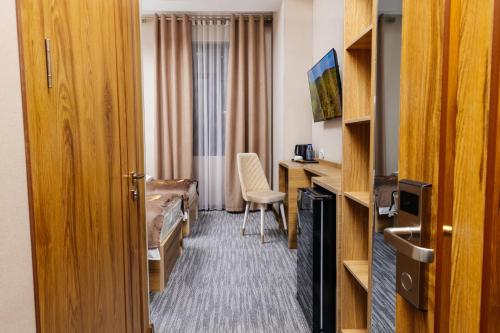 a hotel room with a bed and a desk at Royal Sebzor Hotel in Tashkent