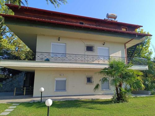a building with a balcony on the side of it at Dimis apartments in Leptokaria